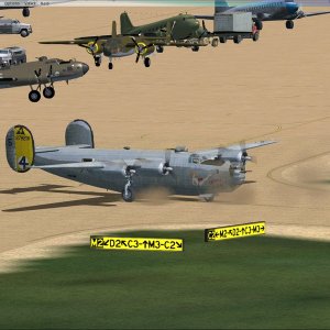 B-24 taxiing past B-17, B-25, and C-47's.